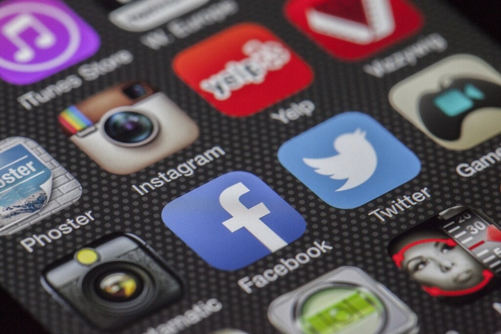 Close-up of a smartphone home screen showing the Facebook and Instagram app icons among other apps (no people, no text b